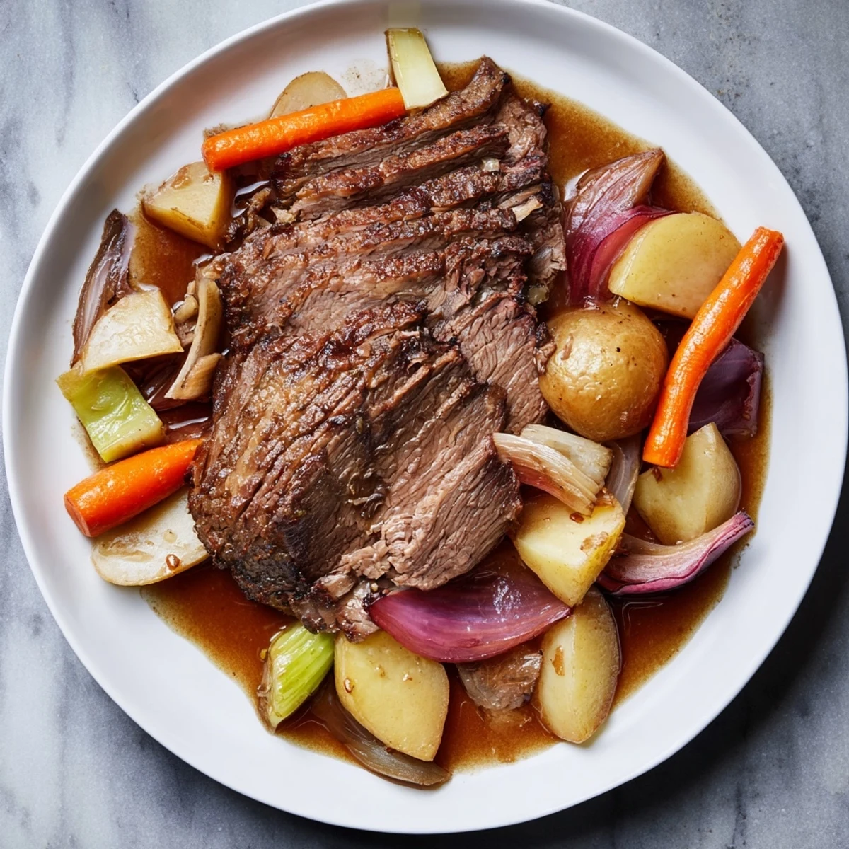 Tender, fall-apart Everyday Family Favorite Pot Roast surrounded by savory root vegetables in rich gravy.