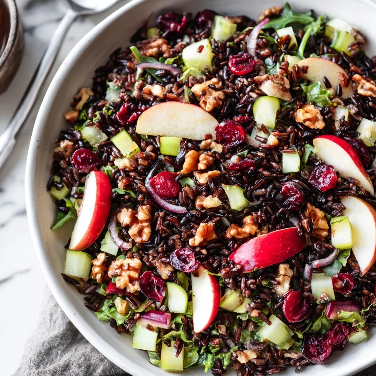 Showcasing a bowl of the delicious Light Forest-Inspired Wild Rice and Cranberry Salad, ready for lunch or a light dinner.