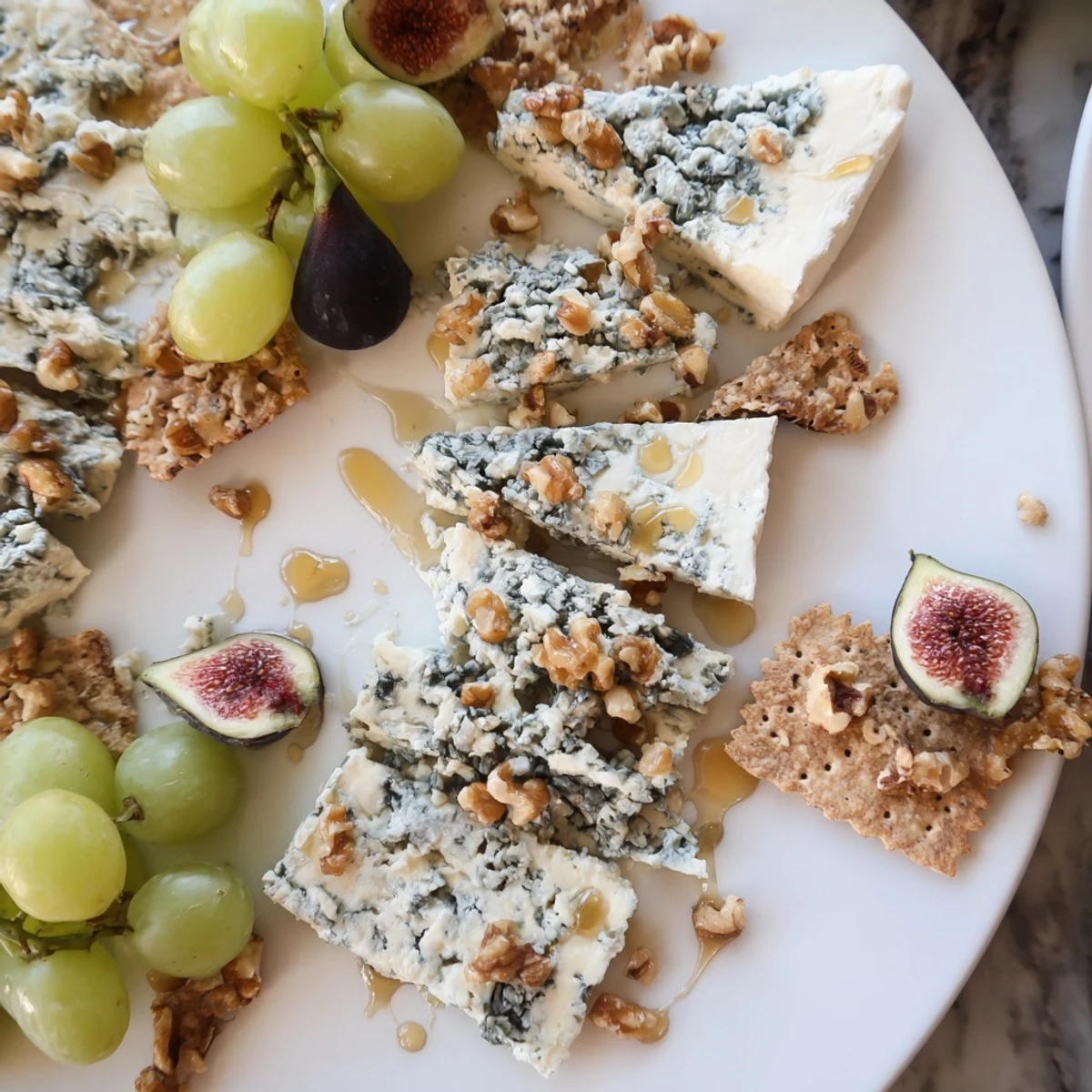 The Blue Ridge Mountains cheese platter: blue cheeses arranged as a mountain range with honey and walnuts, ready to enjoy.