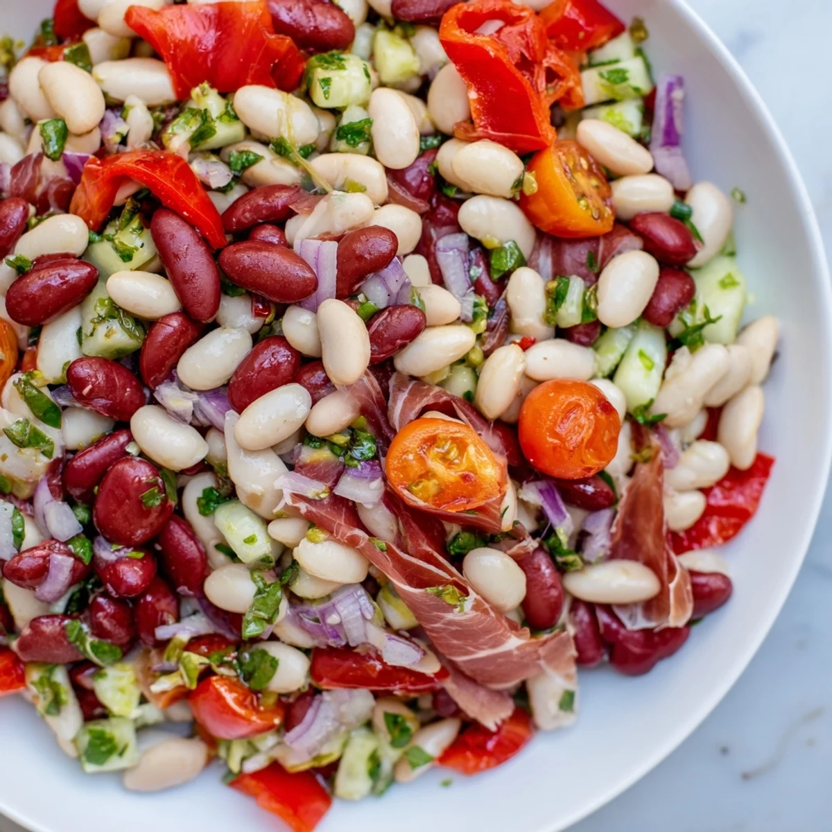 Delicious Dense Bean Salad with Prosciutto, featuring colorful veggies and salty Italian prosciutto ribbons.