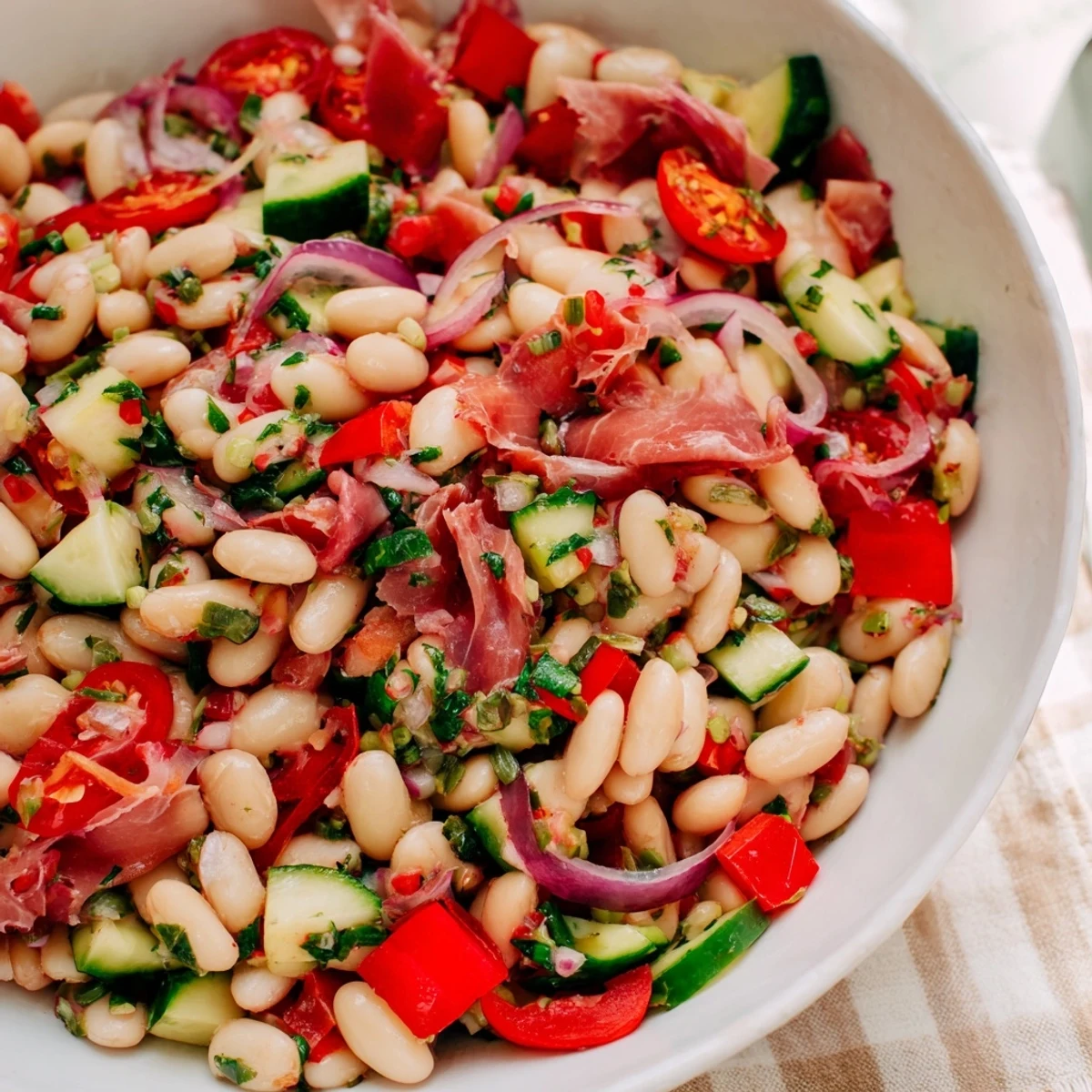 A close-up shot of the vibrant Dense Bean Salad with Prosciutto, ready to serve and enjoy.