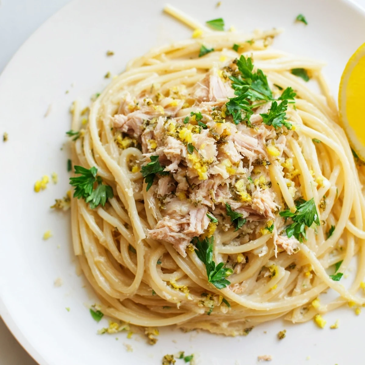 Lemon-Garlic Tuna Spaghetti glistens: a warm bowl of pasta with flaked tuna, lemon, and garlic.