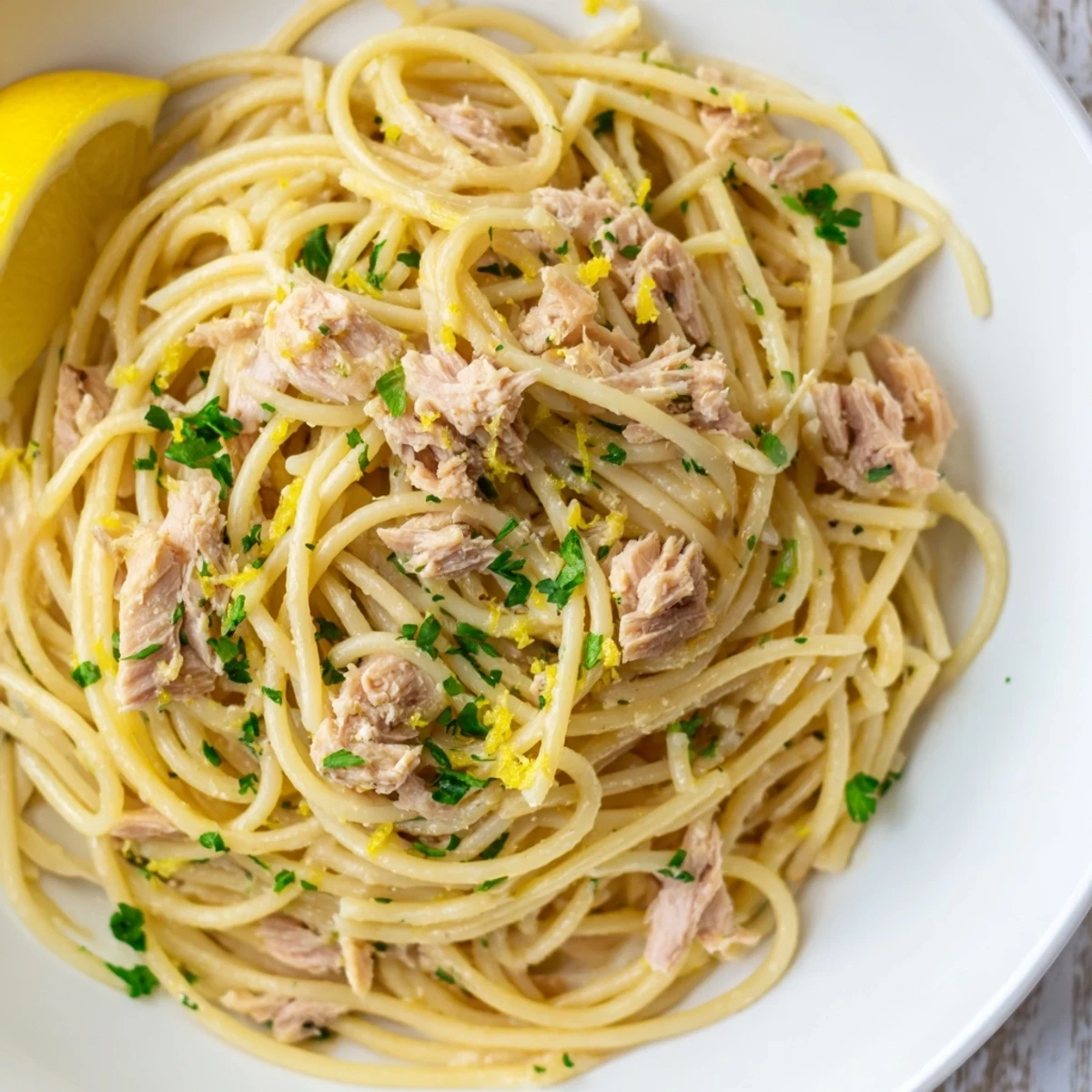 Close-up of Lemon-Garlic Tuna Spaghetti, with herbs, offering zesty and flavorful weeknight dinner.