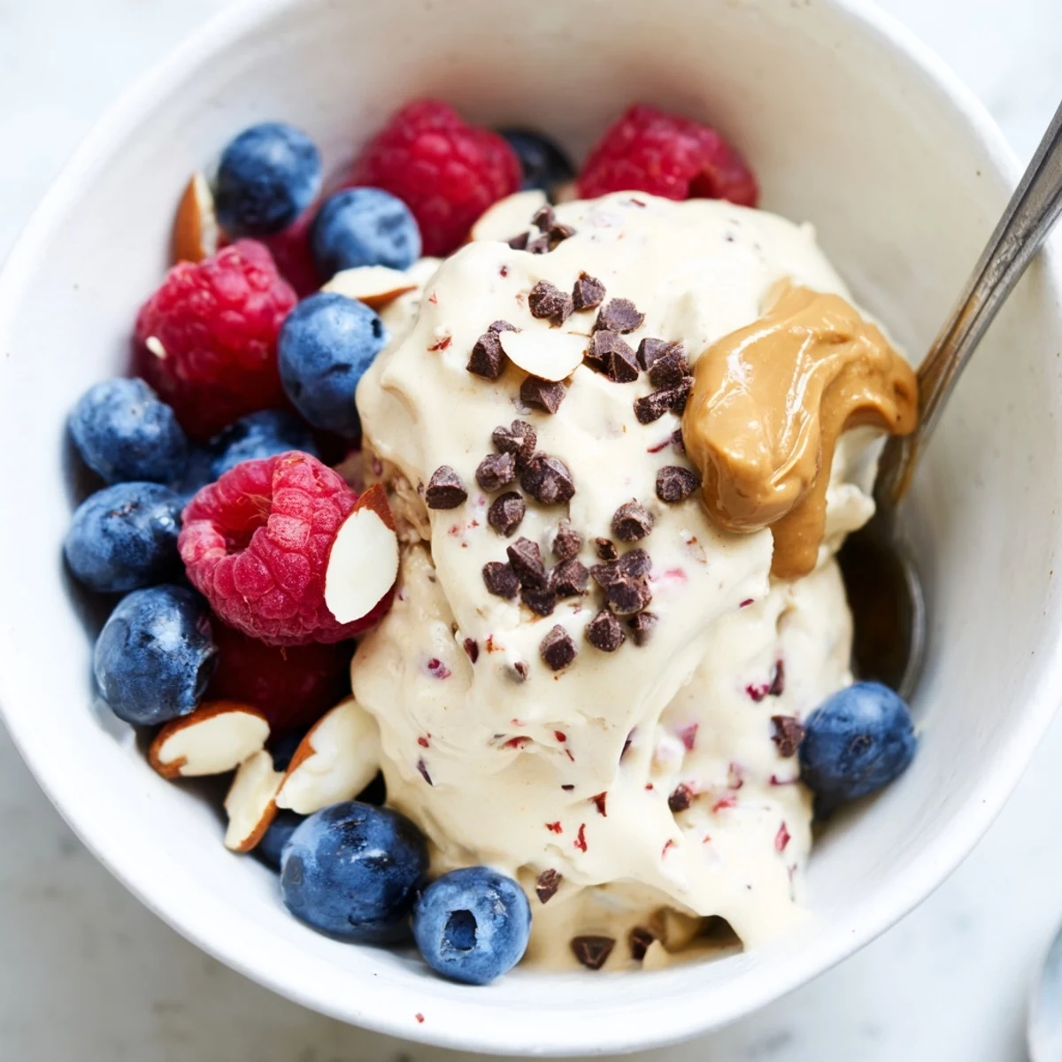 Creamy protein ice cream bowl, swirled with fresh berries, promising a delightful, healthy treat.