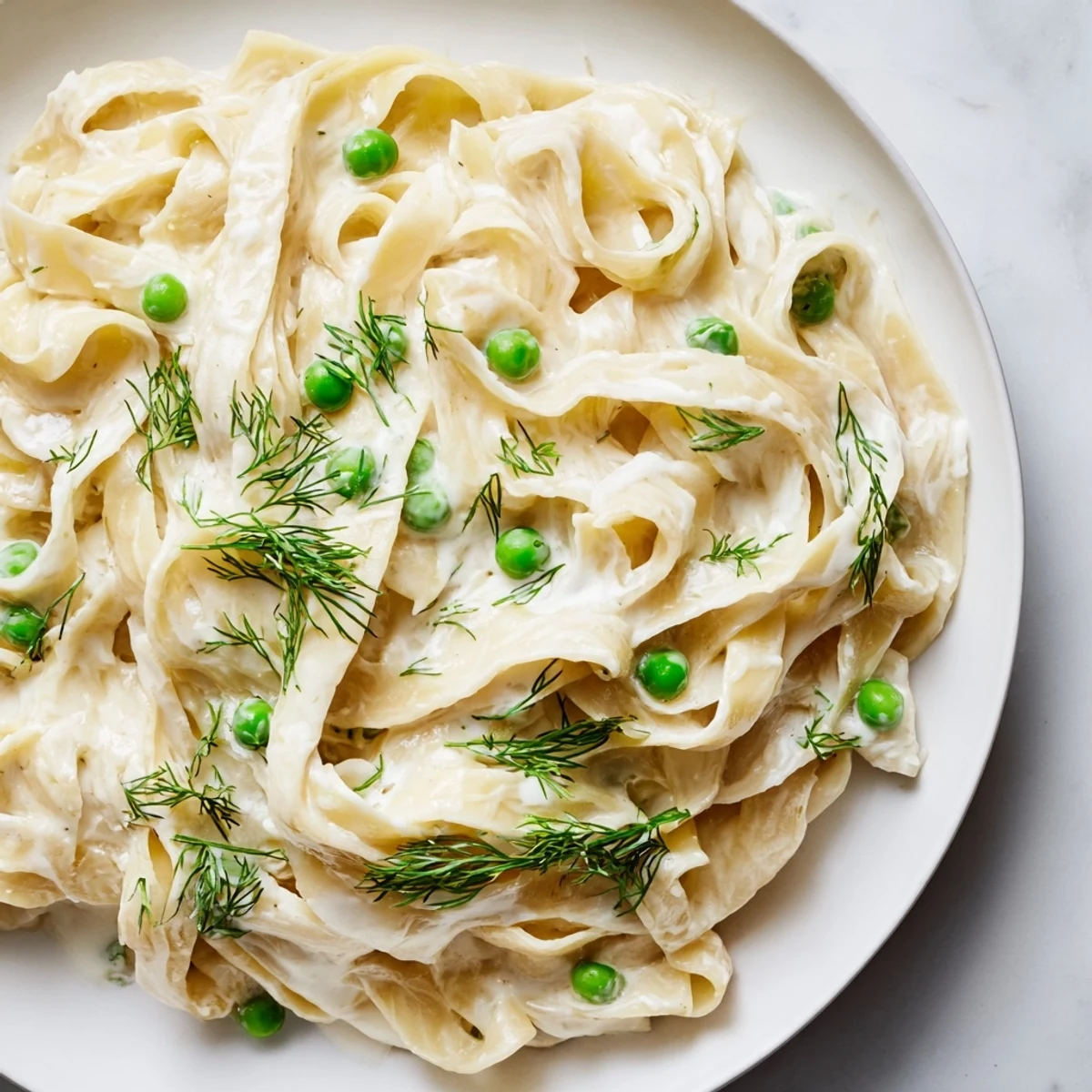 Creamy Dill Pasta swirled in a skillet, glistening with a rich cream sauce and fresh herbs.