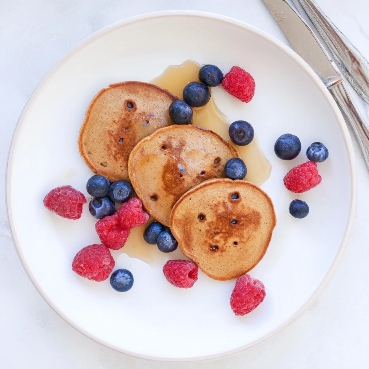 Stack of warm Brown Banana Pancakes showing soft, fluffy texture, ready to be enjoyed for breakfast.