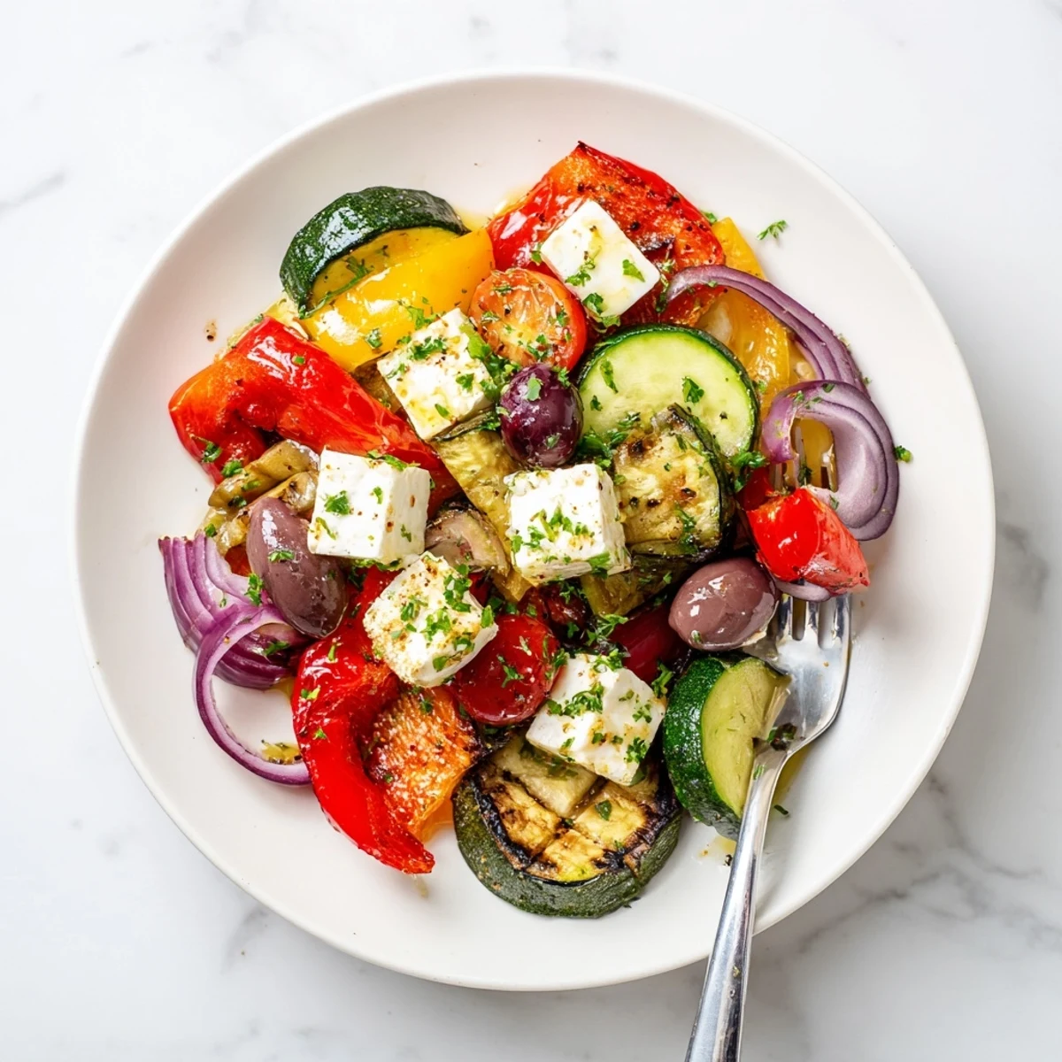 Roasted Greek Salad with caramelized bell peppers, tomatoes, and onions topped with feta and olives.
