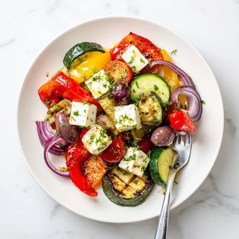 Roasted Greek Salad with caramelized bell peppers, tomatoes, and onions topped with feta and olives.