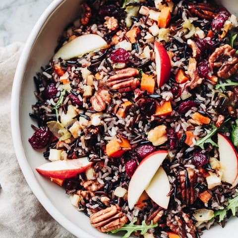 This refreshing Light Forest-Inspired Wild Rice and Cranberry Salad bursts with color and flavor, featuring a tangy dressing.