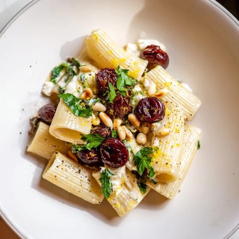 Pasta with Roasted Grapes and ricotta, a visually appealing plate with blistered grapes and creamy sauce.