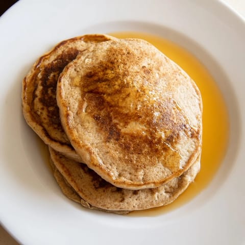 A stack of fluffy banana oat pancakes, warm and inviting for a delicious breakfast.