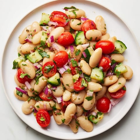 Creamy cannellini beans star in this flavorful white bean salad, perfect for a light vegetarian meal.