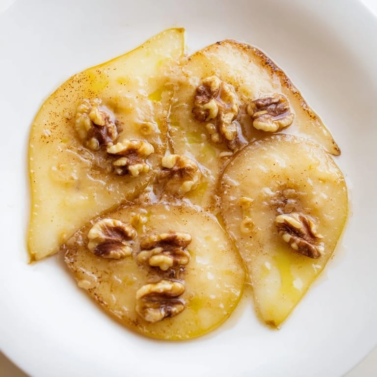 Golden brown Maple-Warm Cozy Plate: Caramelized Pear and Walnut Bake, a comforting dessert with tender pears.