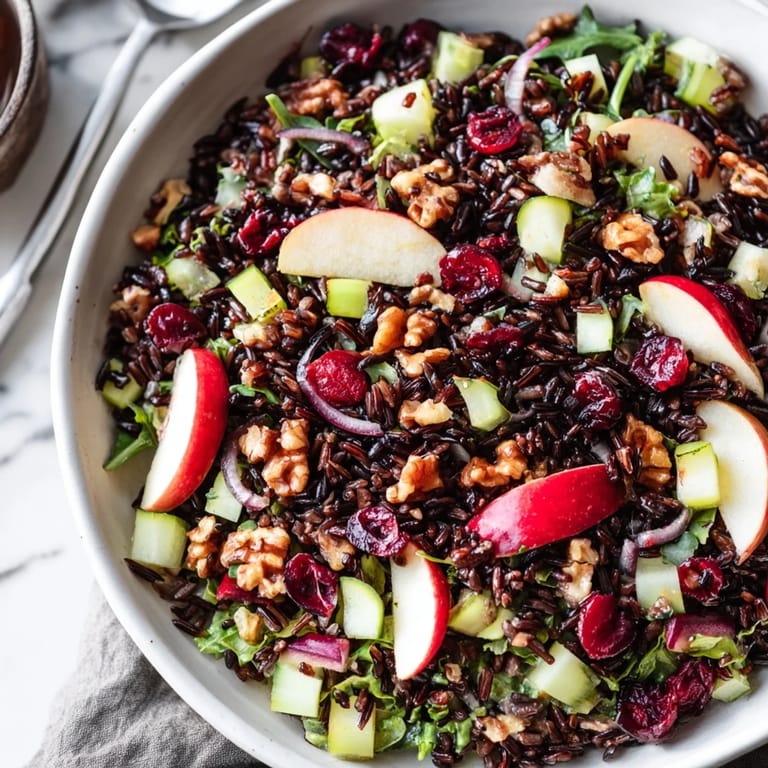 Showcasing a bowl of the delicious Light Forest-Inspired Wild Rice and Cranberry Salad, ready for lunch or a light dinner.