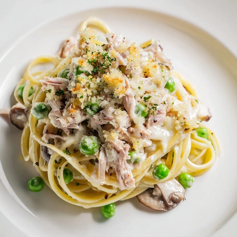 A warm, inviting image of Turkey Tetrazzini; a comforting baked pasta dish with a savory sauce.