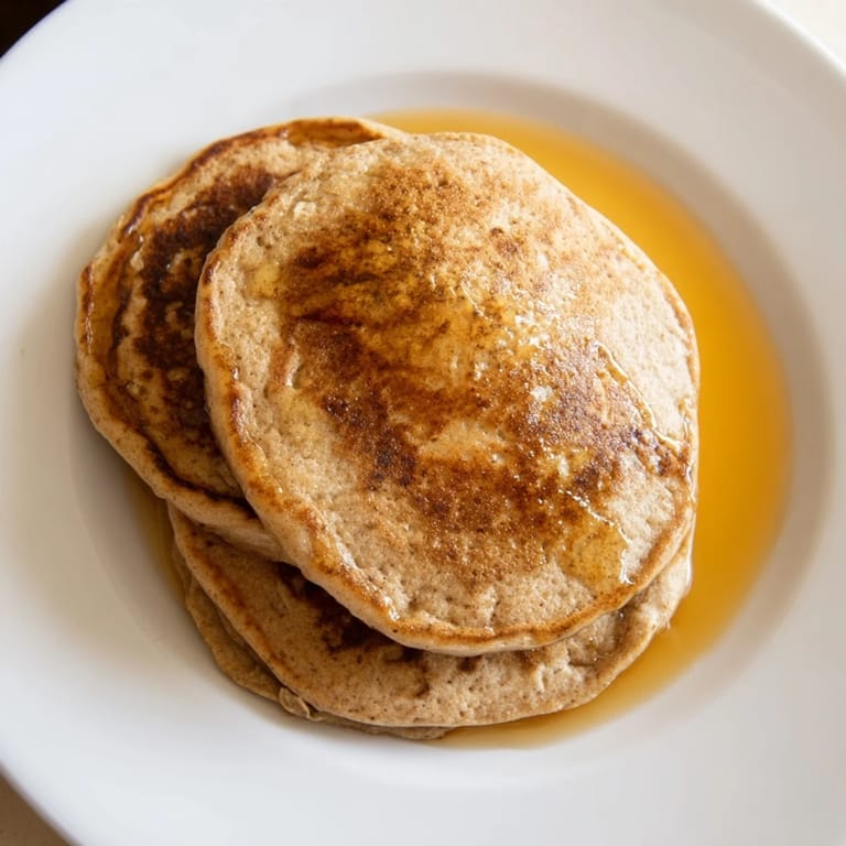 A stack of fluffy banana oat pancakes, warm and inviting for a delicious breakfast.
