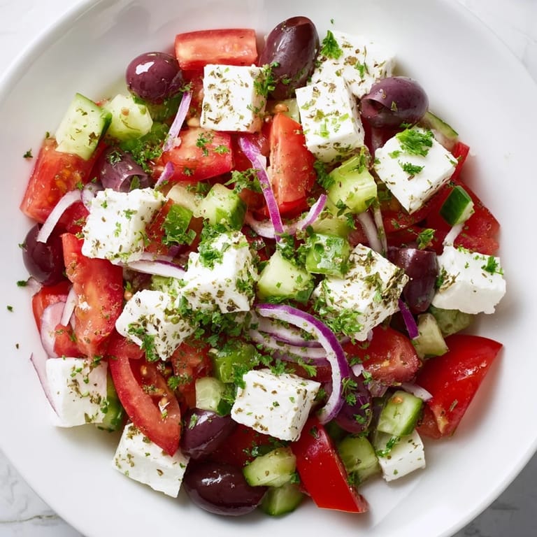 This Mediterranean salad features vibrant veggies and creamy feta, tossed with olive oil dressing.