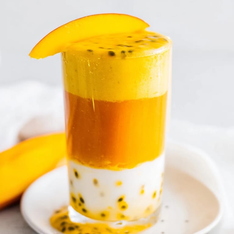 Refreshing and fruity, this Tropical Sunset Smoothie features three colorful, layered, creamy sections.