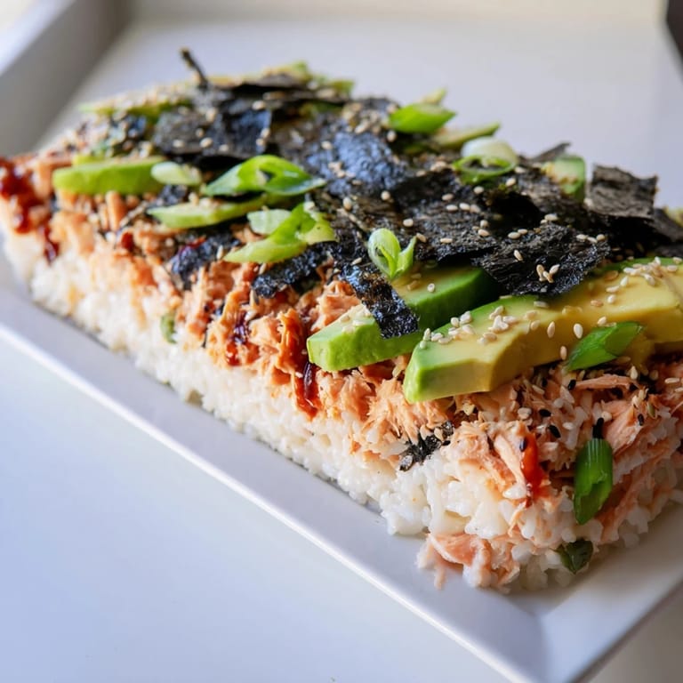 A delicious finished Sushi Bake Casserole, featuring baked salmon and creamy layers, ready to be served.