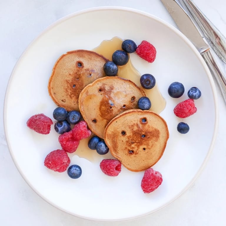 Stack of warm Brown Banana Pancakes showing soft, fluffy texture, ready to be enjoyed for breakfast.